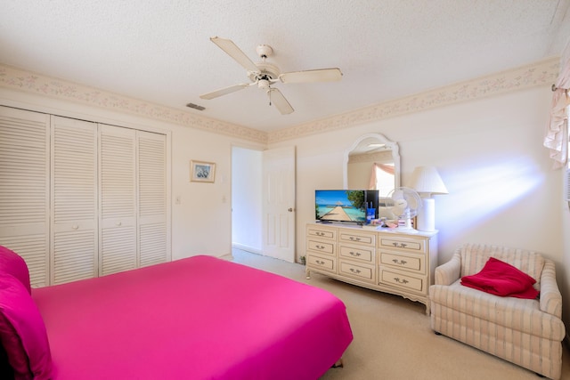 858 SE Roulette Ln, Port Saint Lucie, FL 34983 - bedroom featuring carpet flooring, a closet, a textured ceiling, and ceiling fan