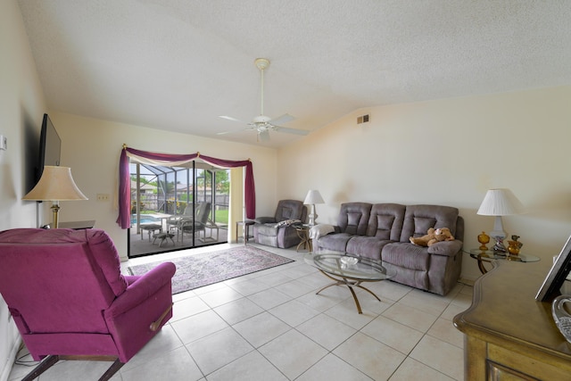 858 SE Roulette Ln, Port Saint Lucie, FL 34983 - living area with lofted ceiling, ceiling fan, light tile patterned floors, and a textured ceiling