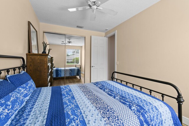 256 Coconut Pt, Jupiter, FL 33458 - bedroom with wood finished floors, ceiling fan, a textured ceiling, baseboards, and a closet