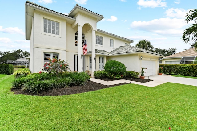 256 Coconut Pt, Jupiter, FL 33458 - view of front of property featuring concrete driveway, a garage, a front lawn, stucco siding, and a tiled roof