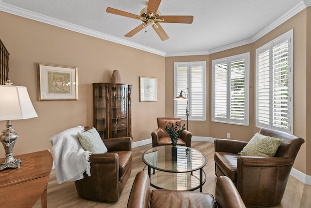 256 Coconut Pt, Jupiter, FL 33458 - living area featuring light wood-type flooring, a ceiling fan, ornamental molding, baseboards, and a textured ceiling