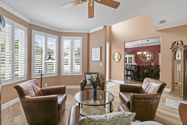256 Coconut Pt, Jupiter, FL 33458 - living room featuring ceiling fan, light wood-type flooring, crown molding, a chandelier, and a textured ceiling