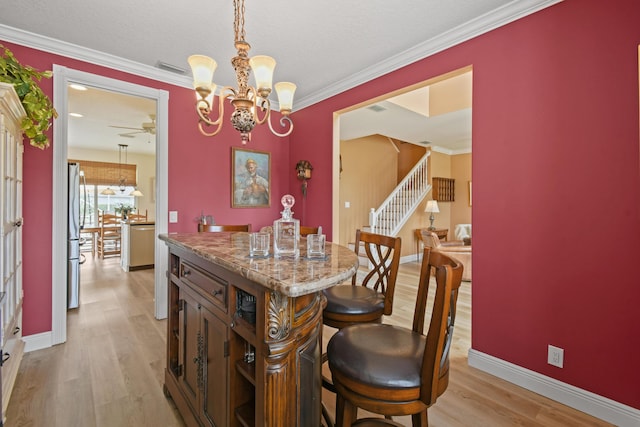 256 Coconut Pt, Jupiter, FL 33458 - dining room with light wood-style flooring, a chandelier, stairway, a ceiling fan, and baseboards