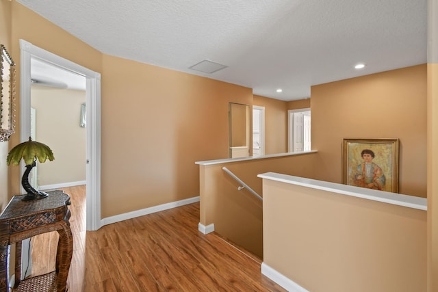 256 Coconut Pt, Jupiter, FL 33458 - hall featuring an upstairs landing, wood finished floors, baseboards, recessed lighting, and a textured ceiling