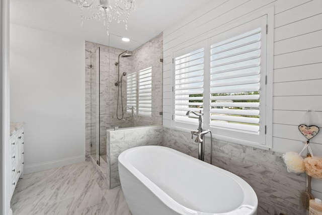 256 Coconut Pt, Jupiter, FL 33458 - full bathroom featuring a stall shower, a chandelier, a soaking tub, vanity, and marble finish flooring