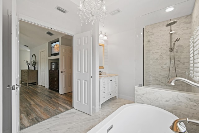 256 Coconut Pt, Jupiter, FL 33458 - bathroom with vanity, a soaking tub, tiled shower, and a chandelier