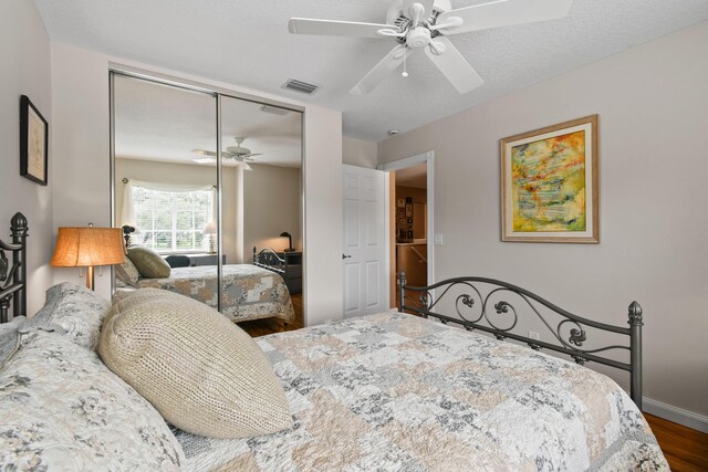 256 Coconut Pt, Jupiter, FL 33458 - bedroom with a closet, wood finished floors, a ceiling fan, and baseboards