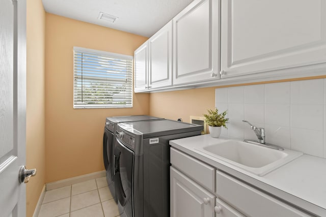 256 Coconut Pt, Jupiter, FL 33458 - laundry room with cabinet space, separate washer and dryer, light tile patterned flooring, and baseboards