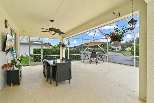 256 Coconut Pt, Jupiter, FL 33458 - view of patio / terrace featuring outdoor dining area, a ceiling fan, a water view, and glass enclosure