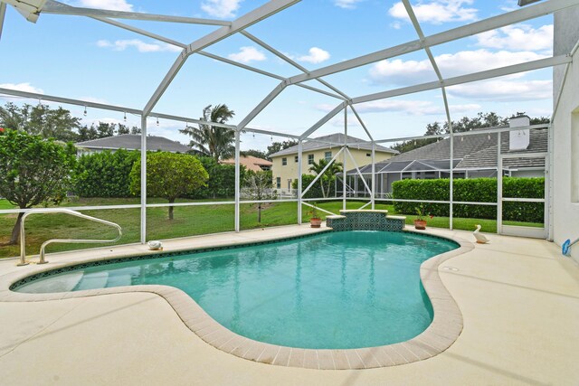 256 Coconut Pt, Jupiter, FL 33458 - swimming pool featuring a lawn, a patio area, and a lanai