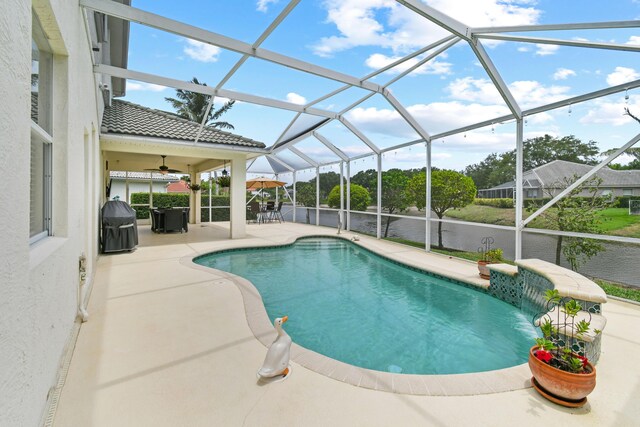 256 Coconut Pt, Jupiter, FL 33458 - swimming pool with a patio, ceiling fan, glass enclosure, and a grill