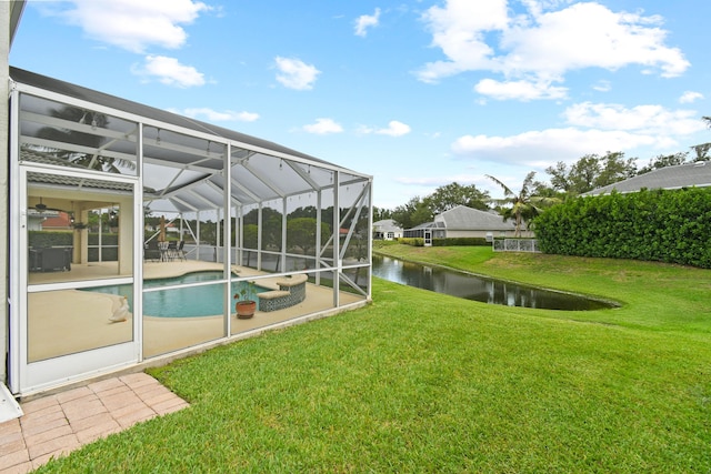 256 Coconut Pt, Jupiter, FL 33458 - view of green lawn featuring a patio area, a water view, and an outdoor pool