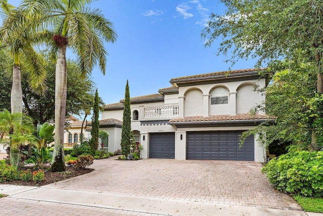 16370 Via Fontana, Delray Beach, FL 33484 - mediterranean / spanish home featuring a balcony, a garage, decorative driveway, and stucco siding