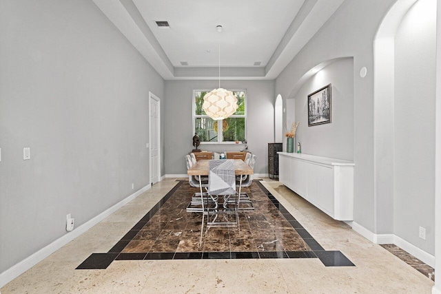 16370 Via Fontana, Delray Beach, FL 33484 - dining space featuring inlaid floor details, arched walkways, baseboards, and a tray ceiling