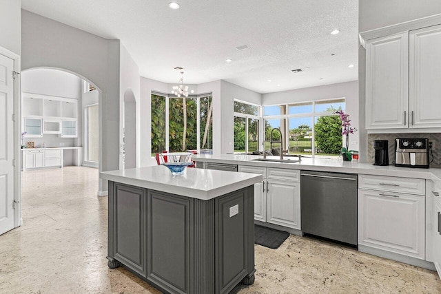 16370 Via Fontana, Delray Beach, FL 33484 - kitchen featuring dishwasher, a sink, a chandelier, a kitchen island, and white cabinets