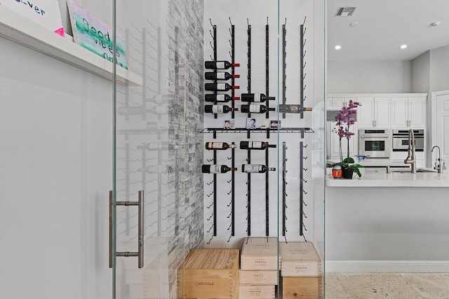 16370 Via Fontana, Delray Beach, FL 33484 - wine cellar featuring recessed lighting, baseboards, and a sink
