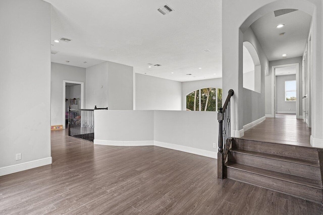 16370 Via Fontana, Delray Beach, FL 33484 - empty room with healthy amount of natural light, wood finished floors, baseboards, and recessed lighting