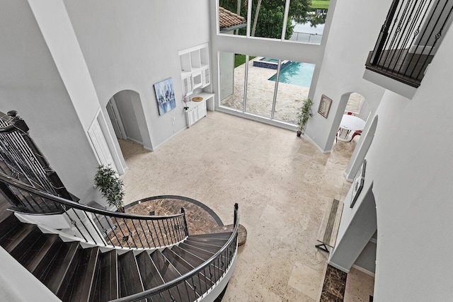 16370 Via Fontana, Delray Beach, FL 33484 - stairway with a towering ceiling, arched walkways, and baseboards