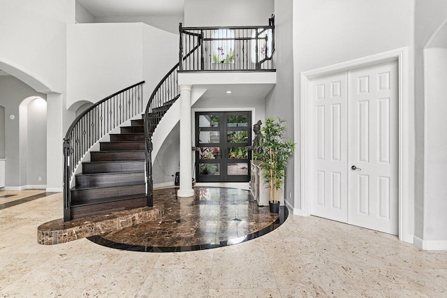 16370 Via Fontana, Delray Beach, FL 33484 - entrance foyer with inlaid floor details, a high ceiling, arched walkways, baseboards, and stairway