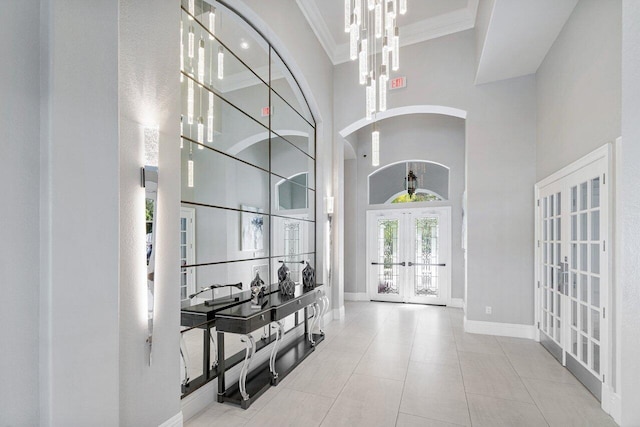 16370 Via Fontana, Delray Beach, FL 33484 - foyer entrance featuring french doors, a high ceiling, baseboards, arched walkways, and ornamental molding