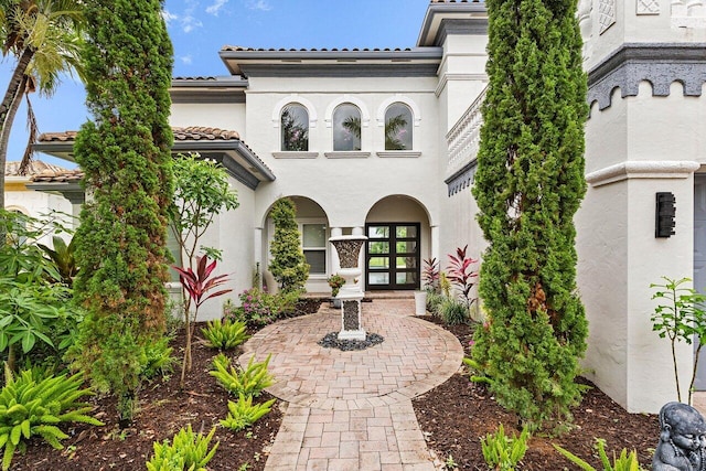16370 Via Fontana, Delray Beach, FL 33484 - property entrance with french doors, a tile roof, and stucco siding