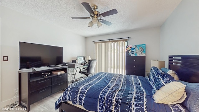 8912 Thumbwood Cir Unit C, Boynton Beach, FL 33436 - bedroom featuring a textured ceiling, light wood-type flooring, a ceiling fan, baseboards, and a desk