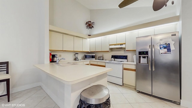 8912 Thumbwood Cir Unit C, Boynton Beach, FL 33436 - kitchen featuring appliances with stainless steel finishes, under cabinet range hood, a sink, a peninsula, and light tile patterned flooring