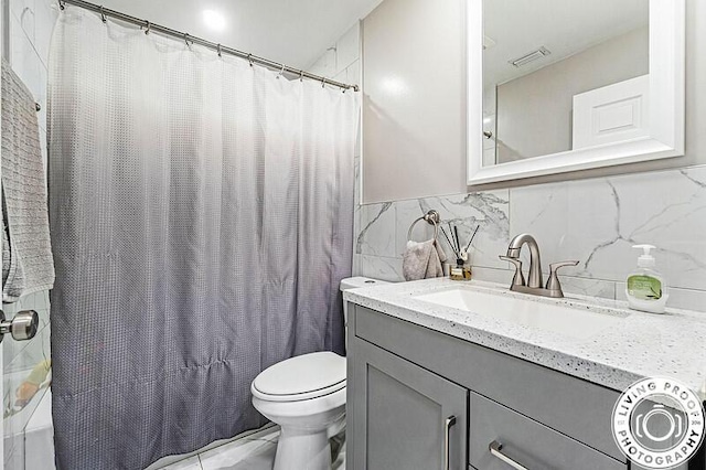 4038 Calamondin Blvd, The Acreage, FL 33470 - full bathroom with vanity, toilet, tile walls, shower / bath combo with shower curtain, and marble finish flooring