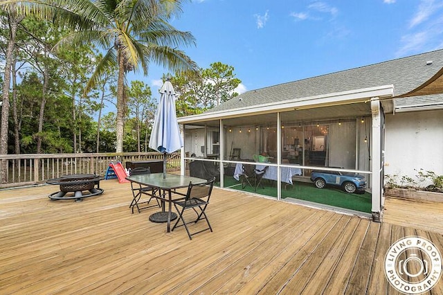 4038 Calamondin Blvd, The Acreage, FL 33470 - wooden deck featuring a fire pit, outdoor dining area, and a sunroom