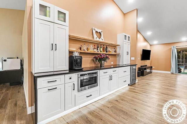 4038 Calamondin Blvd, The Acreage, FL 33470 - bar area with light wood-style flooring, baseboards, high vaulted ceiling, and recessed lighting