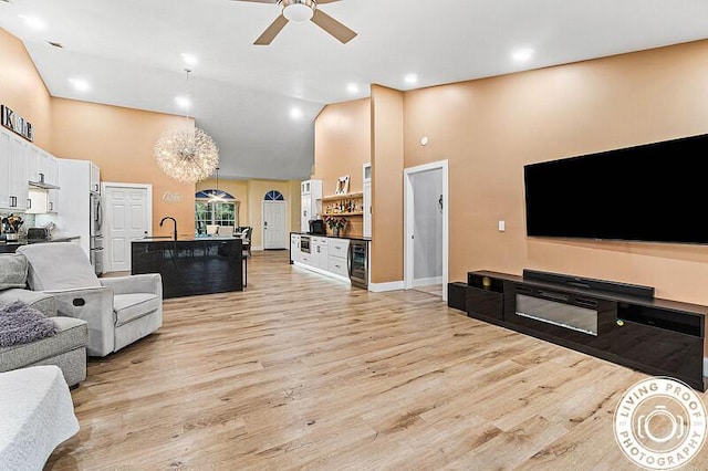4038 Calamondin Blvd, The Acreage, FL 33470 - living area featuring high vaulted ceiling, ceiling fan, light wood-type flooring, and beverage cooler