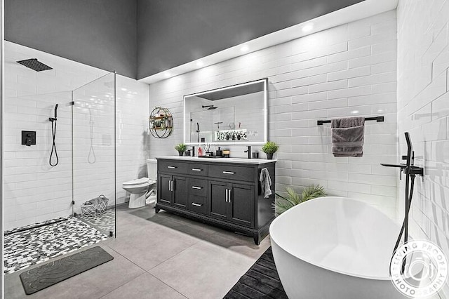 4038 Calamondin Blvd, The Acreage, FL 33470 - bathroom featuring vanity, a freestanding bath, walk in shower, tile patterned flooring, and tile walls