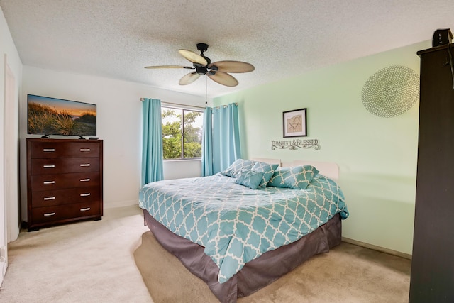 3154 Via Poinciana Unit 409, Lake Worth, FL 33467 - bedroom with light carpet, a textured ceiling, baseboards, and a ceiling fan