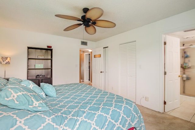 3154 Via Poinciana Unit 409, Lake Worth, FL 33467 - bedroom featuring multiple closets, carpet flooring, a ceiling fan, and connected bathroom