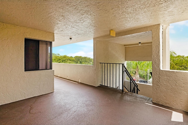 3154 Via Poinciana Unit 409, Lake Worth, FL 33467 - unfurnished room with a textured wall, plenty of natural light, and a textured ceiling