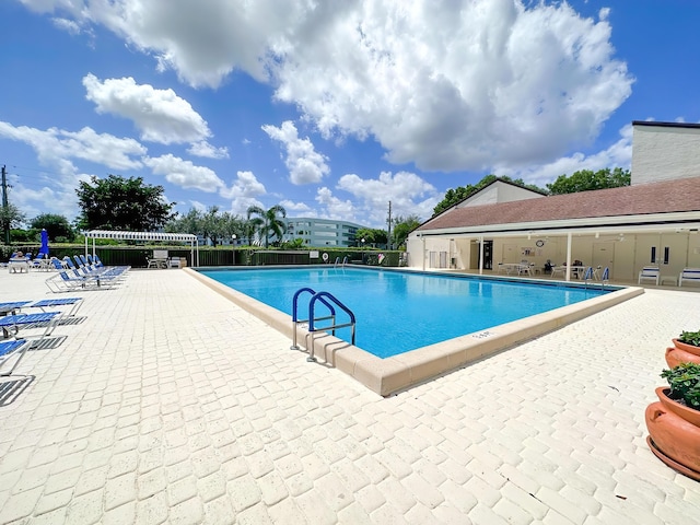 3154 Via Poinciana Unit 409, Lake Worth, FL 33467 - community pool featuring a patio area