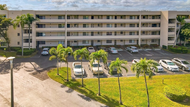 3154 Via Poinciana Unit 409, Lake Worth, FL 33467 - view of apartment building / complex featuring uncovered parking