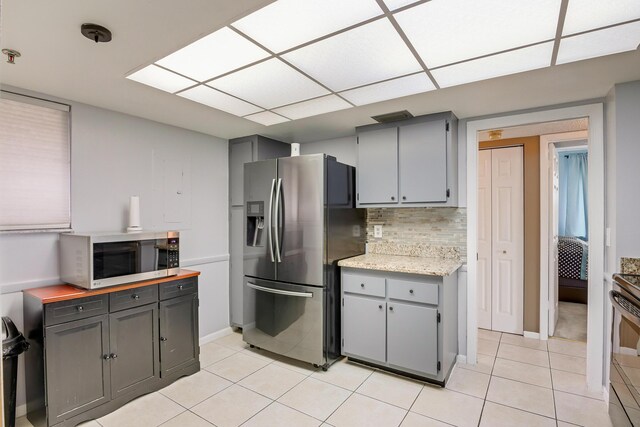 3154 Via Poinciana Unit 409, Lake Worth, FL 33467 - kitchen with appliances with stainless steel finishes, gray cabinets, light tile patterned floors, and light countertops
