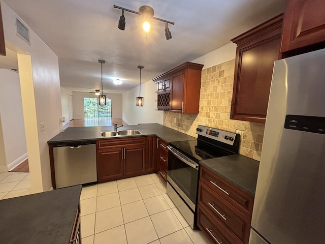2895 SW 22nd Ave Unit 2060, Delray Beach, FL 33445 - kitchen with appliances with stainless steel finishes, dark countertops, ceiling fan, light tile patterned flooring, and decorative backsplash