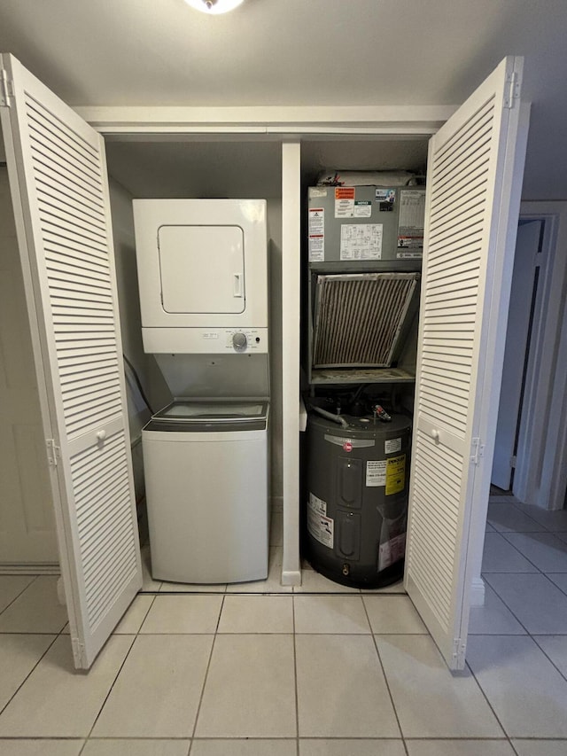 2895 SW 22nd Ave Unit 2060, Delray Beach, FL 33445 - laundry room with stacked washer and clothes dryer, water heater, and light tile patterned flooring
