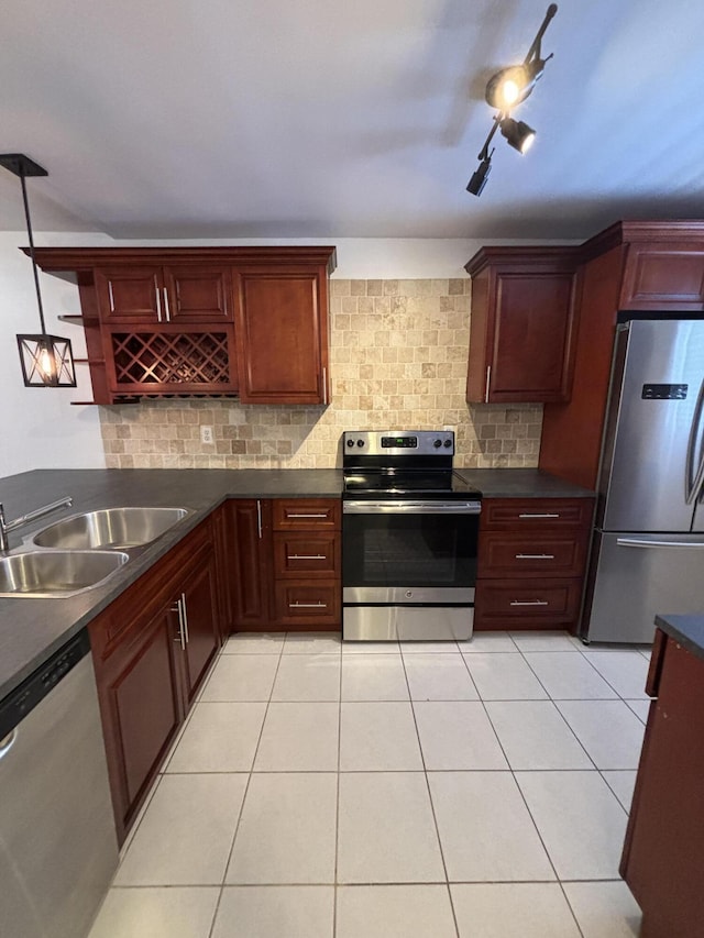 2895 SW 22nd Ave Unit 2060, Delray Beach, FL 33445 - kitchen with appliances with stainless steel finishes, dark countertops, decorative backsplash, light tile patterned floors, and reddish brown cabinets