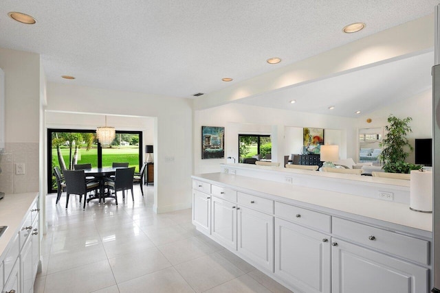 4483 Meadowlark Ln, Boynton Beach, FL 33436 - kitchen with light countertops, light tile patterned flooring, open floor plan, baseboards, and recessed lighting
