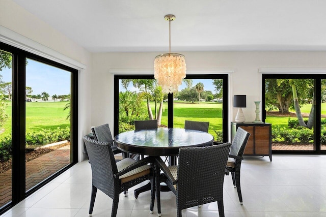 4483 Meadowlark Ln, Boynton Beach, FL 33436 - dining room featuring healthy amount of natural light, a chandelier, light tile patterned floors, and golf course view