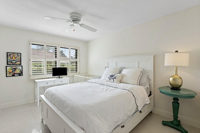4483 Meadowlark Ln, Boynton Beach, FL 33436 - bedroom with light tile patterned flooring, baseboards, a ceiling fan, and a textured ceiling