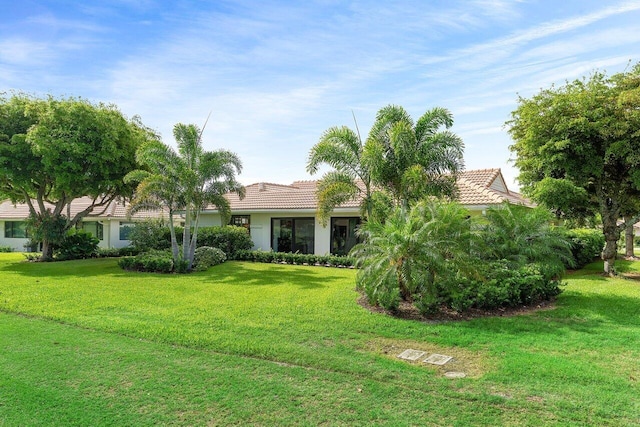 4483 Meadowlark Ln, Boynton Beach, FL 33436 - view of front of property featuring a tile roof, a front yard, and stucco siding