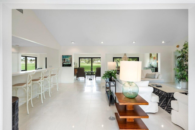4483 Meadowlark Ln, Boynton Beach, FL 33436 - living area with light tile patterned floors, vaulted ceiling, and recessed lighting