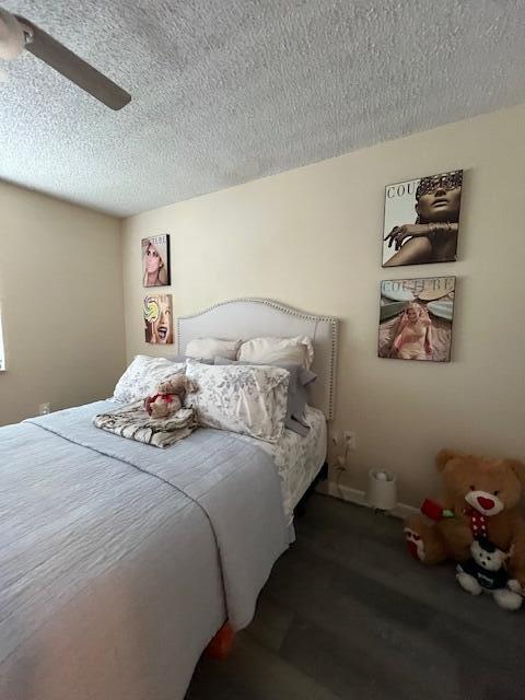 3153 Clint Moore Rd Unit 204, Boca Raton, FL 33496 - bedroom featuring a textured ceiling, a ceiling fan, and wood finished floors