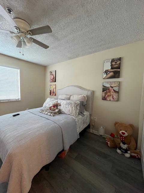 3153 Clint Moore Rd Unit 204, Boca Raton, FL 33496 - bedroom with a textured ceiling, wood finished floors, and ceiling fan