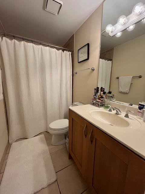 3153 Clint Moore Rd Unit 204, Boca Raton, FL 33496 - full bathroom with vanity, toilet, and tile patterned floors