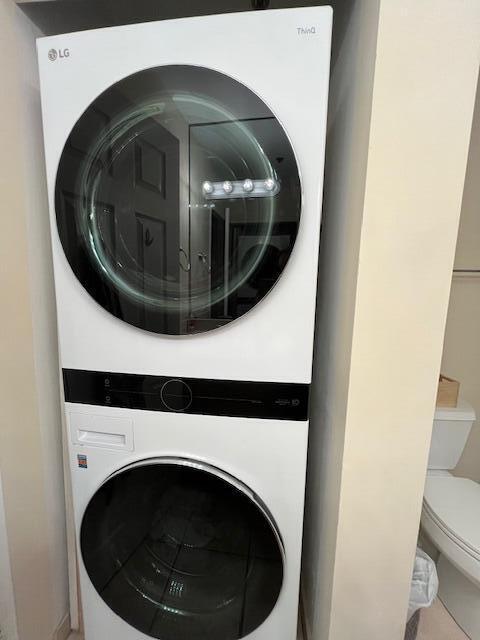 3153 Clint Moore Rd Unit 204, Boca Raton, FL 33496 - laundry room featuring estacked washer and dryer